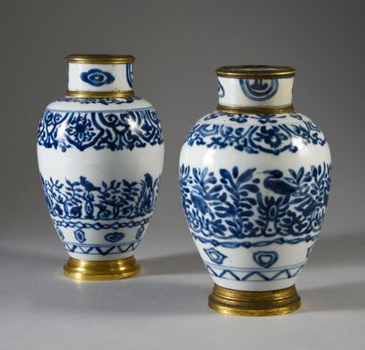 CHINE Two covered porcelain vases with white and blue decorations with a frieze of...