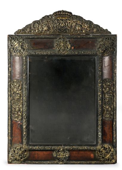 null An important mirror with pediment, the scale-plated frame is richly decorated...