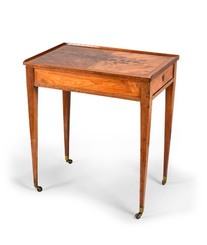 null Rosewood veneered writing table in violet wood frames, the top decorated in...