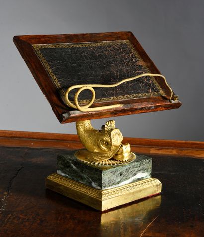 null Lectern in ambony burr veneer, it rests on a chased and gilded bronze dolphin...
