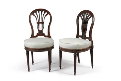 null Two chairs in stained beech wood, openwork backrest, horseshoe seat decorated...