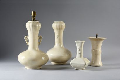 null Two garlic-headed vases with white glaze, the flattened globular belly extended...