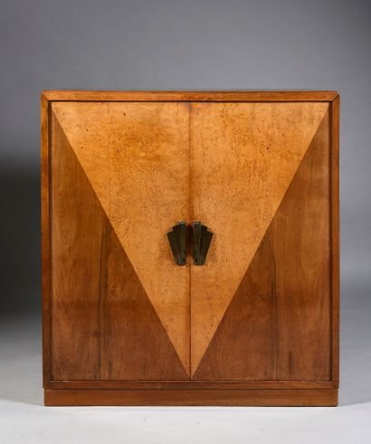 null A two-leaf cabinet with a V-shaped veneer in burr sycamore on a mahogany background....