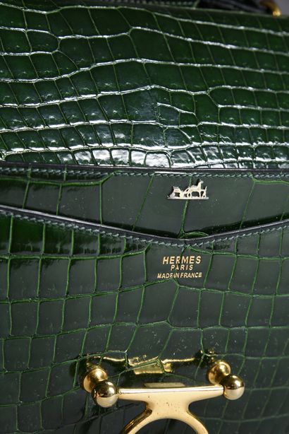 HERMES 
Sequana clutch bag, emerald green Niloticus crocodile, gold-plated trim.