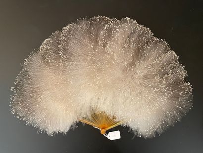 null Powdered white, circa 1900

Small ostrich feather down fan.

The frame is entirely...