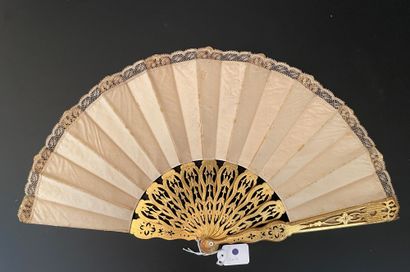 null Golden Sultana, circa 1880

Folded fan, the cream satin leaf embroidered with...