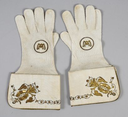 null . Pair of liturgical gloves with crispins, early 20th century, cream cotton...