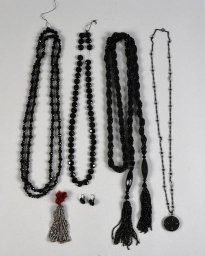 null . Set of four black glass bead necklaces and long necklaces, circa 1920, small...