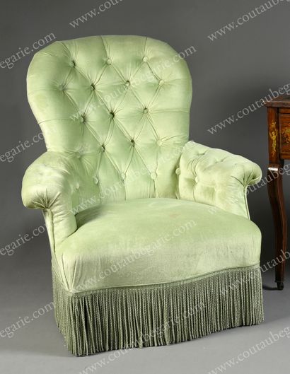 null CAPITONED ARMCHAIR.
In light green velvet, resting on four legs, two of which...