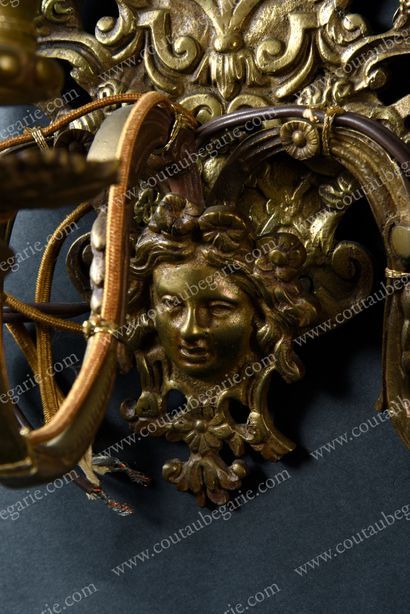 null Pair of wall lights.
In gilt bronze, with three arms of light, decorated with...