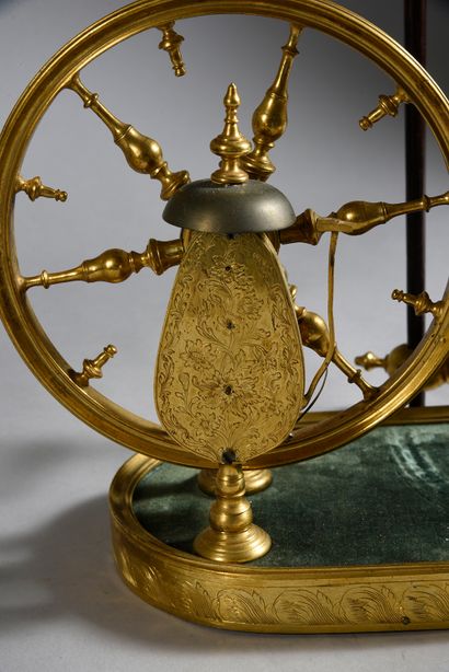 null Gilt bronze and rosewood table wheel, the dark green velvet top, the wheel with...