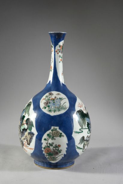 null A Chinese porcelain bottle-shaped vase with a blue background decorated with...