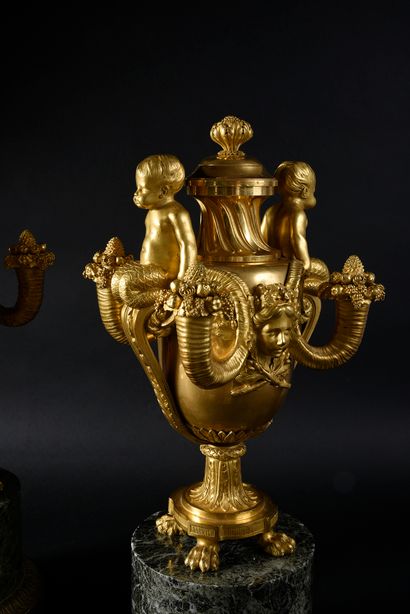 null Pair of vases-candelabra with triton child.
Chased and gilded bronze.
Each ovoid...
