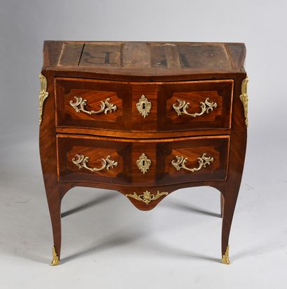 null A rosewood veneered chest of drawers with amaranth frames, opening to two drawers...