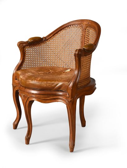null Caned desk armchair in natural moulded wood, the back in gondola, it rests on...