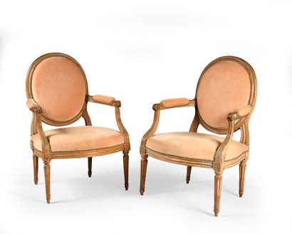 null Pair of moulded and stripped wooden armchairs with flat medallion backs, resting...