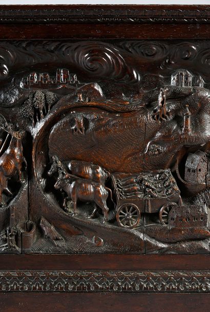 null Walnut chest, the front carved with a scene of ox teams carrying the corpses...