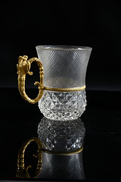 null A diamond-cut crystal mug in two registers, the chased and gilt bronze handle...