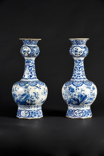 DELFT Pair of bottle vases with blue camaïeu decoration of birds and flowery cartouches.
H....