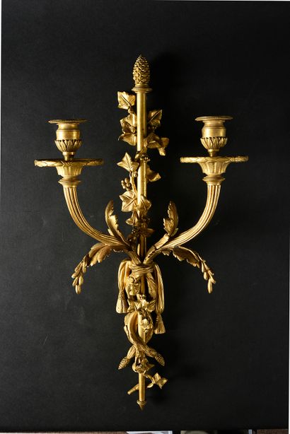 null A pair of two-light sconces in chased and gilt bronze.
After the model delivered...