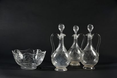 null Suite of 3 carafons and a bowl in wheel-cut crystal with foliage decoration.
Attributed...