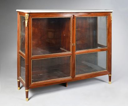 A mahogany and mahogany veneer bookcase with...