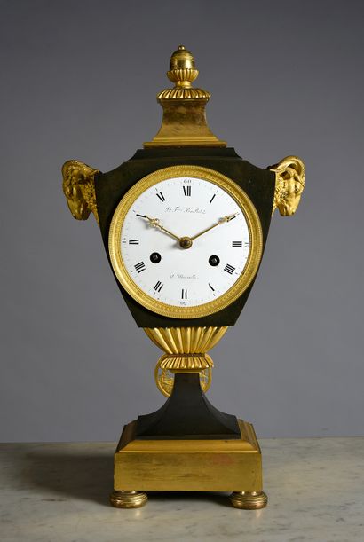 null Chased, patinated and gilded bronze clock, the body simulating a covered vase...