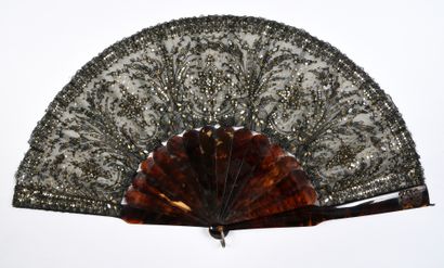 null Sequins and lace, circa 1880
Folded fan, the leaf in black lace, with spindles,...