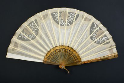 null Gilded chevrons, circa 1910
Folded fan, the ivory-colored silk leaf embroidered...