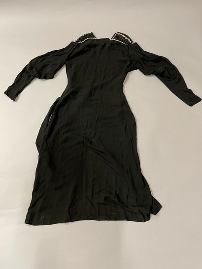  Two dresses, circa 1930, one with long sleeves in black silk crepe, the more remarkable...