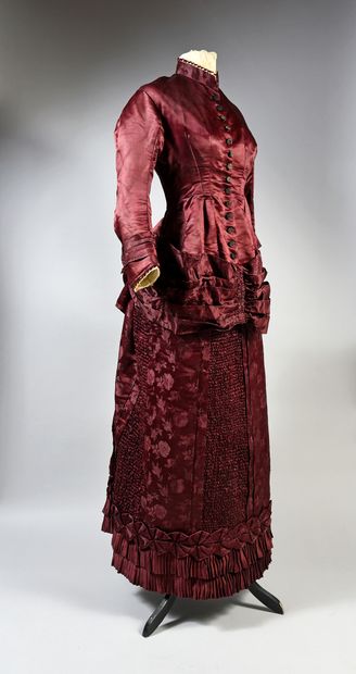  Elegant day dress, circa 1885, made of satin and damask with natural rose design....