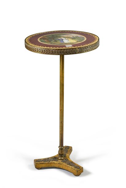 null Rare tripod pedestal table, the base in gilded cast iron with applied decoration...