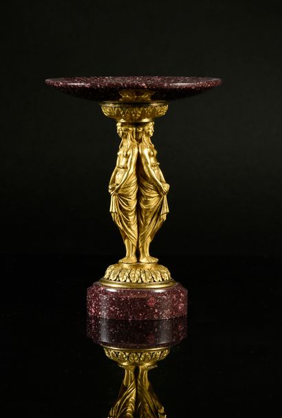 null A finely chased and gilded bronze cup on a foot, the shaft formed by three women...