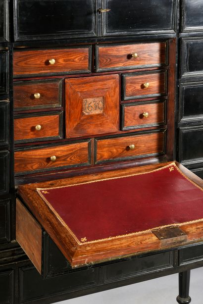 null Ebony cabinet opening with 12 drawers and a flap, revealing 8 drawers veneered...