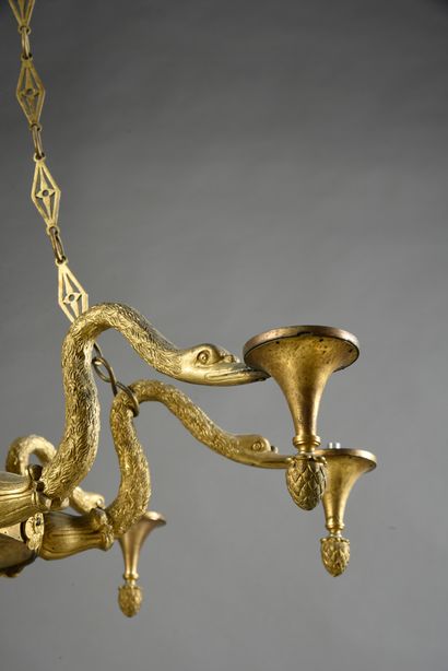 null A chased and gilded bronze chandelier with 8 lights, the body simulating a large...