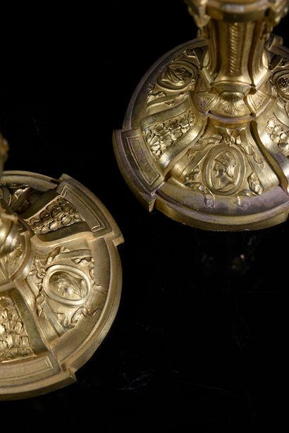 null Pair of chased and gilded bronze torches, the base with contours decorated with...