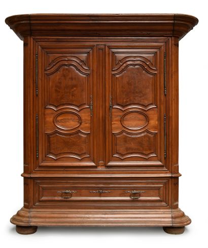 null Bordelaise cabinet in moulded fruitwood opening to two large leaves and a drawer,...