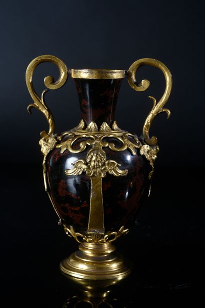 null A pair of mahogany obsidian vases, the gilded copper frame decorated with winged...