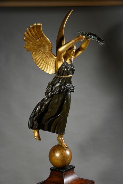 null A winged Victory in carved wood with patina and gilding in imitation of bronze,...
