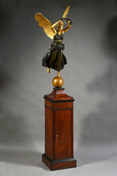 A winged Victory in carved wood with patina...
