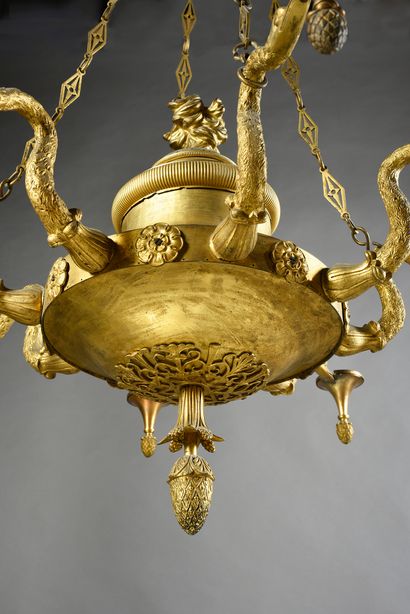 null A chased and gilded bronze chandelier with 8 lights, the body simulating a large...