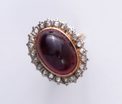 null 585th gold ring, set with a large garnet cabochon in a scalloped setting set...