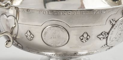 null Silver bowl with two handles, resting on a pedestal with water leaves.
Early...