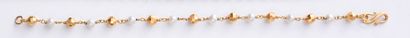 null Gold bracelet 750th, alternated with cultured pearls and faceted gold balls,...