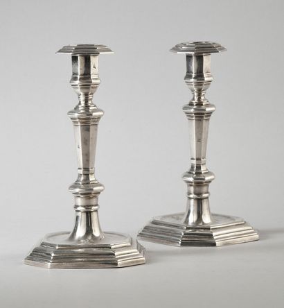 A pair of silver torches, the octagonal base...