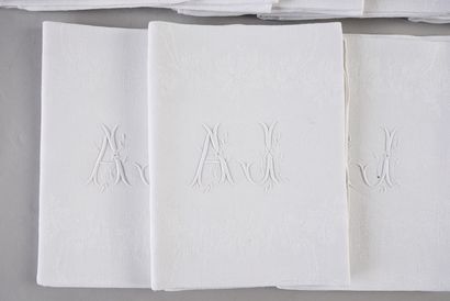 null A dozen linen damask napkins, circa 1900, wreath of foliage on the center bristling...