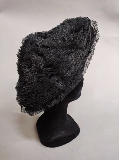null 539. Meeting of hats, circa 1950, mainly a black lace lace tiered and pleated...