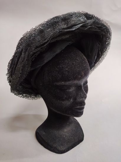 null 539. Meeting of hats, circa 1950, mainly a black lace lace tiered and pleated...