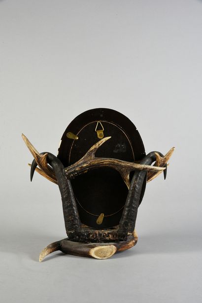 null Mirror in a bone frame, resting on a mount of deer, stag and chamois antlers,...