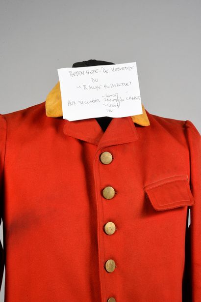 null Dress of venery red with orange facings, flat buttons. With a handwritten label:...